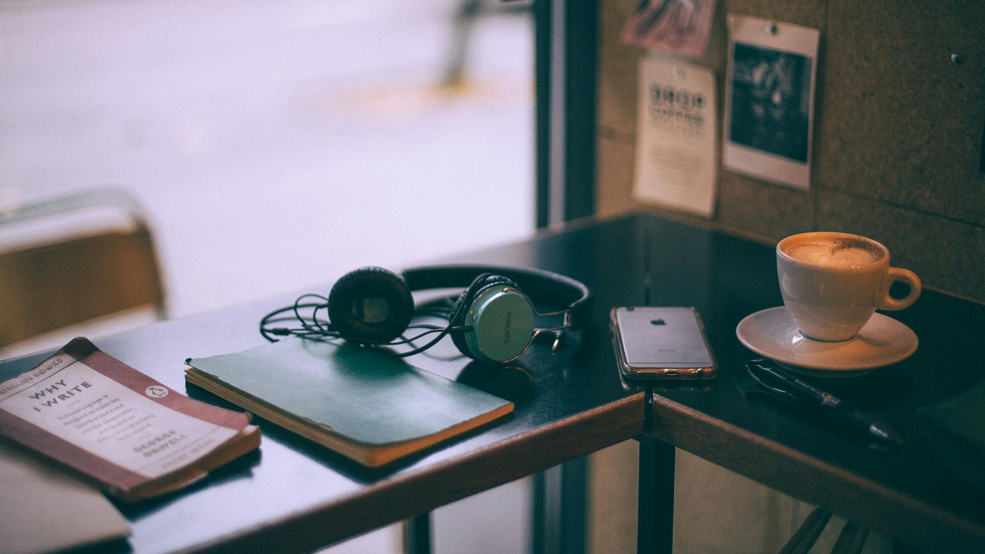 Coffee and headphones on cafe table